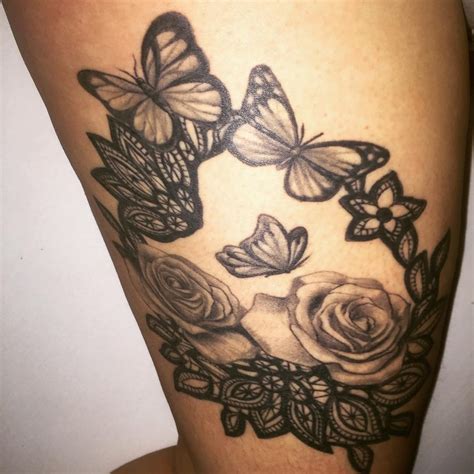 butterfly tattoo with flowers around it